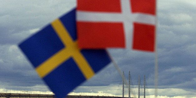 Swedish (L) and Danish flags are seen near the Oresund Bridge July 1. The bridge-tunnel link between Denmark and Sweden was inaugurated Saturday by Queen Margrethe II of Denmark and King Carl XVI Gustaf of Sweden. The rail-and-road link connects the Danish capital Copenhagen with southern Sweden across the 16-kilometer wide Oresund strait.hen/hsh