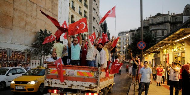 People in a truck wave Turkish flags in Istanbul on July 16, 2016 near Taksim square during a demonstration in support to Turkish president.President Recep Tayyip Erdogan battled to regain control over Turkey on July 16, 2016 after a coup that claimed more than 250 lives, bid by discontented soldiers, as signs grew that the most serious challenge to his 13 years of dominant rule was faltering. / AFP / YASIN AKGUL (Photo credit should read YASIN AKGUL/AFP/Getty Images)