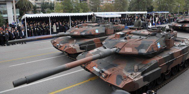 Soldiers stand on tanks as they take part in a military parade in Thessaloniki on October 28, 2014, during the celebrations marking Greece's National 'Oxi ' (No) Day, commemorating Greece's refusal to accept the italian ultimatum advanced by Benito Mussolini in 1940 during World War II. The parade was held under tight security after celebrations in 2011 were disrupted by anti-austerity protesters.AFP PHOTO /Sakis Mitrolidis (Photo credit should read SAKIS MITROLIDIS/AFP/Getty Images)