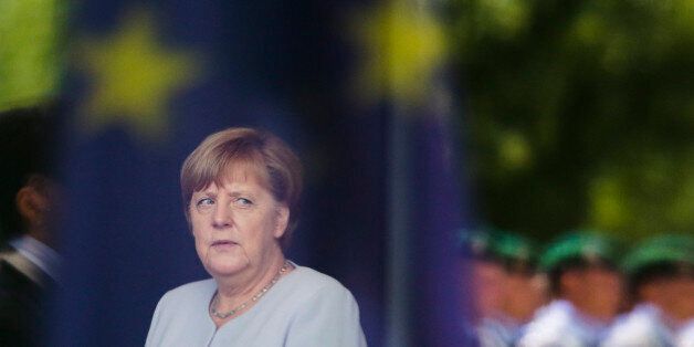 In this photo taken through a window with the reflection of an European flag German Chancellor Angela Merkel waits for the Prime Minister of the Ukraine Volodymyr Groysman at the chancellery in Berlin, Monday, June 27, 2016. Merkel later on Monday meets French President Francois Hollande, Italian Prime Minister Matteo Renzi and European Council President Donald Tusk, ahead of an EU-wide summit Tuesday and Wednesday. (AP Photo/Markus Schreiber)