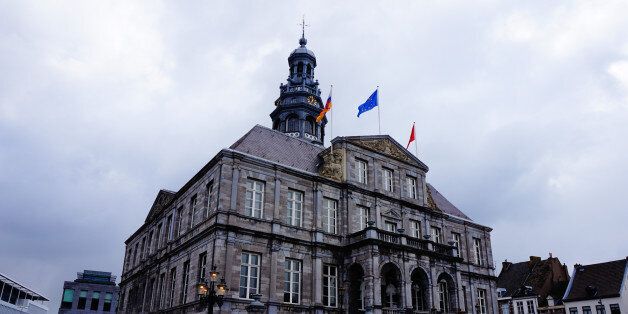 A view on the city hall of Maastricht, located on the 'Markt' Square in the old city centre of Maastricht, Zuid Limburg, the Netherlands. Built in the period of 1659-1665 and designed by architect Pieter Post. The Building includes elements of the Classicist style. Sky with clouds.