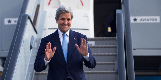 US Secretary of State John Kerry waves as he steps off his plane after arriving at Kastrup International Airport, Thursday, June 16, 2016, in Copenhagen. (AP Photo/Evan Vucci, Pool)