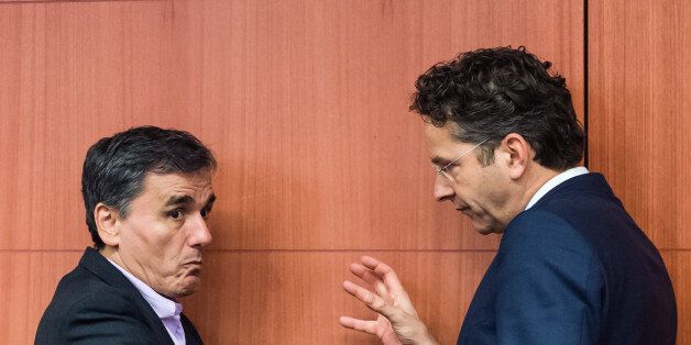 Greece's Finance Minister Euclid Tsakalotos, left, talks with Dutch Finance Minister and chair of the eurogroup of finance ministers, Jeroen Dijsselbloem, during a Eurogroup finance ministers meeting at the EU Council building in Brussels Monday, Dec. 7, 2015. (AP Photo/Geert Vanden Wijngaert)