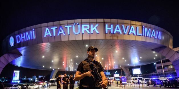 A Turkish riot police officer patrols Ataturk airport`s main enterance in Istanbul, on June 28, 2016, after two explosions followed by gunfire hit Turkey's largest airport, killing at least 10 people and injuring 20. All flights at Istanbul's Ataturk international airport were suspended on June 28, 2016 after a suicide attack left at least 36 people dead. / AFP / OZAN KOSE (Photo credit should read OZAN KOSE/AFP/Getty Images)