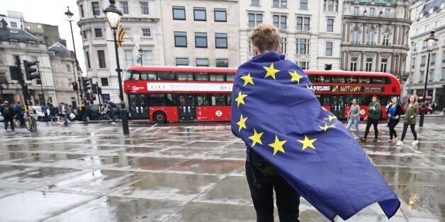 A demonstrator wrapped in a European flag leaves an anti-Brexit protest in Trafalgar Square in central London on June 28, 2016.EU leaders attempted to rescue the European project and Prime Minister David Cameron sought to calm fears over Britain's vote to leave the bloc as ratings agencies downgraded the country. Britain has been pitched into uncertainty by the June 23 referendum result, with Cameron announcing his resignation, the economy facing a string of shocks and Scotland making a fresh threat to break away. / AFP / JUSTIN TALLIS (Photo credit should read JUSTIN TALLIS/AFP/Getty Images)