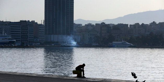 A migrant sits at the Athens port of Piraeus, Monday April 4, 2016, during the first day of the implementation of the deal between EU and Turkey. Under the deal, migrants arriving illegally in Greece will be returned to Turkey if they do not apply for asylum or if they make an asylum claim that is rejected. (AP Photo/Lefteris Pitarakis)