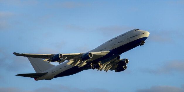 Giant airplane takes off from Heathrow Airport and undercarriage retracts under it.