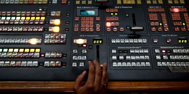 An employee operates a mixing console at the control room of state broadcaster ERT headquarters in Athens June 17, 2013. Greek Prime Minister Antonis Samaras faced a double challenge on Monday from coalition partners furious over the shutdown of state broadcaster ERT and a court hearing that could put the shuttered station back on air. REUTERS/Yorgos Karahalis (GREECE - Tags: BUSINESS POLITICS MEDIA EMPLOYMENT)