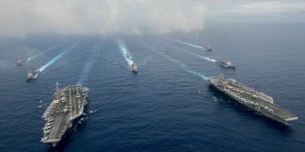 The Nimitz-class aircraft carriers USS John C. Stennis (CVN 74), and USS Ronald Reagan (CVN 76) (R) conduct dual aircraft carrier strike group operations in the U.S. 7th Fleet area of operations in support of security and stability in the Indo-Asia-Pacific in the Philippine Sea on June 18, 2016. Courtesy Jake Greenberg/U.S. Navy/Handout via REUTERS ATTENTION EDITORS - THIS IMAGE WAS PROVIDED BY A THIRD PARTY. EDITORIAL USE ONLY
