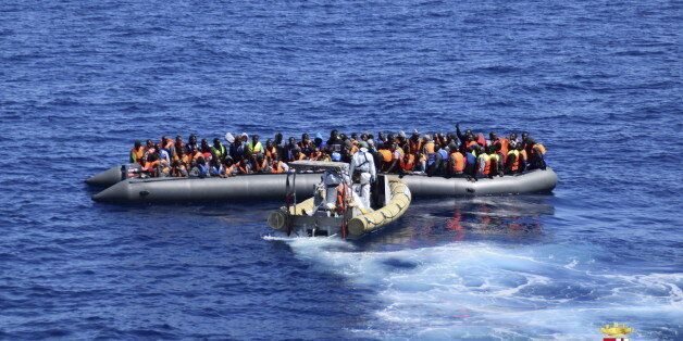 Migrants sit in their boat during a rescue operation by Italian Navy vessels off the coast of Sicily in this April 11, 2016 handout picture provided by Italy's Marina Militare. REUTERS/Marina Militare/Handout via Reuters ATTENTION EDITORS - THIS PICTURE WAS PROVIDED BY A THIRD PARTY. REUTERS IS UNABLE TO INDEPENDENTLY VERIFY THE AUTHENTICITY, CONTENT, LOCATION OR DATE OF THIS IMAGE. FOR EDITORIAL USE ONLY. NOT FOR SALE FOR MARKETING OR ADVERTISING CAMPAIGNS. THIS PICTURE IS DISTRIBUTED EXACTLY AS RECEIVED BY REUTERS, AS A SERVICE TO CLIENTS. TPX IMAGES OF THE DAY