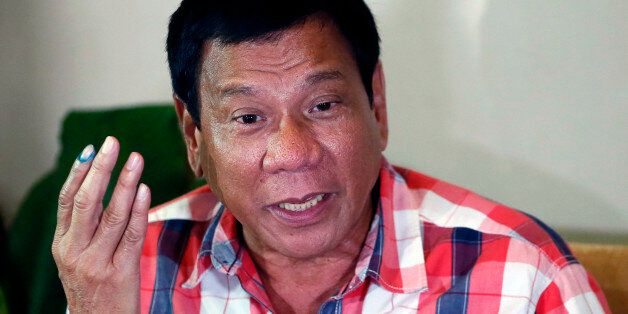 FILE- In this May 9, 2016 file photo, then front-running presidential candidate Mayor Rodrigo Duterte gestures during a news conference in Davao city in southern Philippines. The Philippine president-elect Rodrigo Duterte said Tuesday, June 21, 2016 he recently asked the U.S. ambassador whether Washington will support the Philippines in case of a possible confrontation with China in the disputed South China Sea. (AP Photo/Bullit Marquez, File)