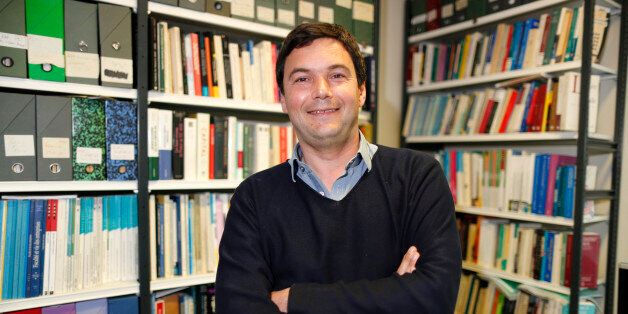 French economist and academic Thomas Piketty, poses in his book-lined office at the French School for Advanced Studies in the Social Sciences (EHESS), in Paris May 12, 2014. The 43-year-old Piketty's book