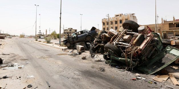 Destroyed vehicles from clashes are seen in Falluja, Iraq, after government forces recaptured the city from Islamic State militants, June 30, 2016. REUTERS/Ahmed Saad
