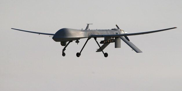 UNSPECIFIED, UNSPECIFIED - JANUARY 07: A U.S. Air Force MQ-1B Predator unmanned aerial vehicle (UAV), carrying a Hellfire missile lands at a secret air base after flying a mission in the Persian Gulf region on January 7, 2016. The U.S. military and coalition forces use the base, located in an undisclosed location, to launch airstrikes against ISIL in Iraq and Syria, as well as to distribute cargo and transport troops supporting Operation Inherent Resolve. The Predators at the base are operated and maintained by the 46th Expeditionary Reconnaissance Squadron, currently attached to the 386th Air Expeditionary Wing. (Photo by John Moore/Getty Images)