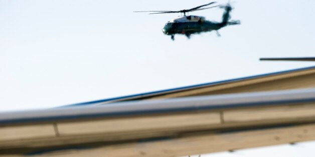 Marine One, bottom, with President Barack Obama aboard, flies behind the wing of Air Force One, at Andrews Air Force Base, Md., Wednesday, June 29, 2016, prior to the president's trip to Ottawa, Canada. (AP Photo/Cliff Owen)