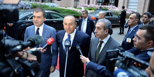 BRUSSELS, BELGIUM - JUNE 30: Turkey's EU Minister Omer Celik (L), Turkish Foreign Minister Mevlut Cavusoglu and Vice chairman of Justice and Development Party, Mehdi Eker (R2) speak to media ahead of the Chapter 33 on financial and budgetary provisions as part of the EU-Turkey Intergovernmental Accession Conference in Brussels, Belgium on June 30, 2016. (Photo by Dursun Aydemir/Anadolu Agency/Getty Images)