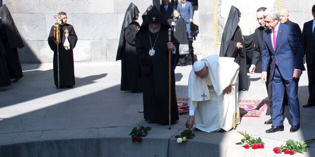 Pope Francis, second right, flanked by Catholicos Karekin II, left, and Armenia's President Serzh Sargsyan, right, places flowers during his visit to Tzitzernakaberd Memorial Complex in Yerevan, Armenia, Saturday, June 25, 2016. (Maurizio Brambatti/Pool Photo via AP)