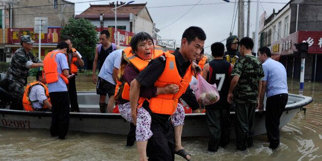 LIU'AN, CHINA - JULY 04: Soldiers rescue residents in Shucheng County on July 4, 2016 in Liu'an, Anhui Province of China. At least 18 people died, 4 were missing and 6.72 million people were affected in the rainstorms since June 18 in Anhui, according to Department of Civil Affairs of Anhui Province on Sunday. (Photo by Wu Fan/VCG via Getty Images)