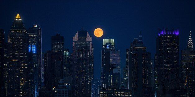 NEW YORK, NY - JUNE 20: The full moon rises above the skyscrapers in Manhattan, New York on June 20, 2016. For the first time since the Summer of Love in 1967, June's full moon, also known as the Strawberry Moon, coincided with the summer solstice. (Photo by Volkan Furuncu/Anadolu Agency/Getty Images)