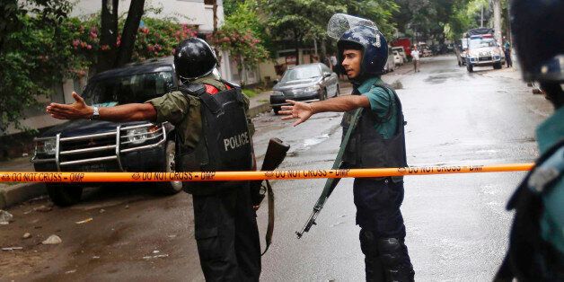 Bangladeshi policemen clear out an area to facilitate action against heavily armed militants who struck at the heart of Bangladesh's diplomatic zone on Friday night, taking dozens of hostages at a restaurant popular with foreigners, Dhaka, Bangladesh, Saturday, July 2, 2016. Police sustained casualties and dozens of people were wounded in a gun battle as security forces cordoned off the area and sought to end the standoff. (AP Photo)
