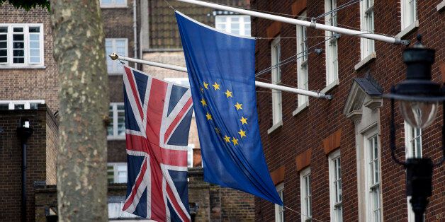 A European, right, and Union flags are displayed outside Europe House, the European Parliament's British offices, in London, Wednesday, June 22, 2016. Britain votes whether to stay in the European Union in a referendum on Thursday. (AP Photo/Matt Dunham)