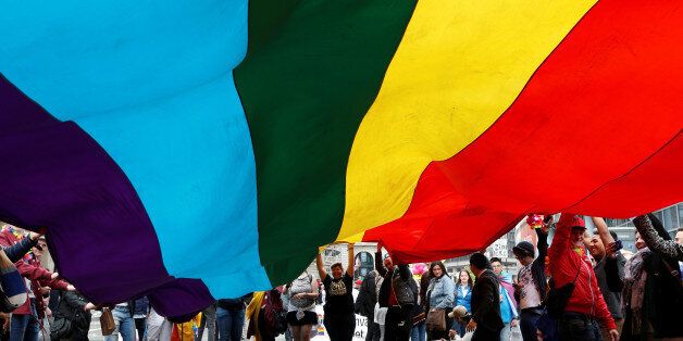 Participants hold a giant rainbow flag during the Belgian LGBT Pride Parade in central Brussels, Belgium, May 14, 2016. REUTERS/Francois Lenoir