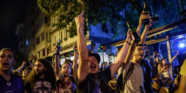 Protester chant slogans against goverment on June 18, 2016 at cihangir district in Istanbul during a demonstration against the islamist attack. British rock group Radiohead on June 18 condemned 'violent intolerance' after Islamists brutally attacked customers at an Istanbul record store attending an album release party, angered that the event coincided with Ramadan. / AFP / OZAN KOSE (Photo credit should read OZAN KOSE/AFP/Getty Images)