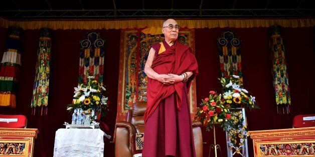 The Dalai Lama takes to the stage to address the faithful in Aldershot on June 29, 2015 which has a large Nepalese Buddhist community made up mainly of serving and retired Gurkha soldiers. AFP PHOTO / BEN STANSALL (Photo credit should read BEN STANSALL,BEN STANSALL/AFP/Getty Images)