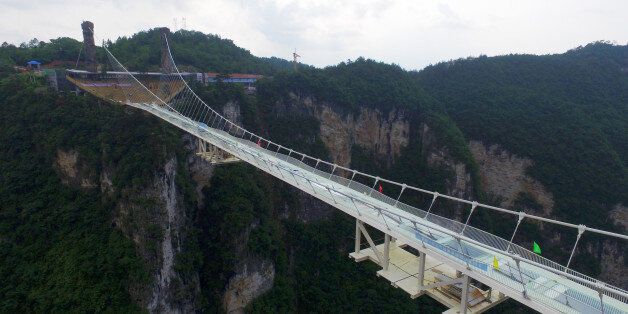 ZHANGJIAJIE, CHINA - JUNE 12: (CHINA OUT) Picture shows the glass-bottomed bridge across the Zhangjiajie Grand Canyon on June 12, 2016 in Zhangjiajie, Hunan Province of China. World's longest and highest glass-bottomed bridge over the Zhangjiajie Grand Canyon will open soon. The bridge stretched 430 meters long, 6 meters wide and the biggest vertical drop was 1,430 meters under the path. (Photo by VCG/VCG via Getty Images)