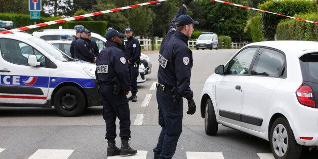 French police officers work at the crime scene the day after a knife-wielding attacker stabbed a senior police officer to death Monday evening outside his home in Magnanville, west of Paris, France, Tuesday, June 14, 2016. The attacker and a female companion of the police commander were later found dead after police commandos stormed the home and rescued the couple's three-year-old son. (AP Photo/Thibault Camus)