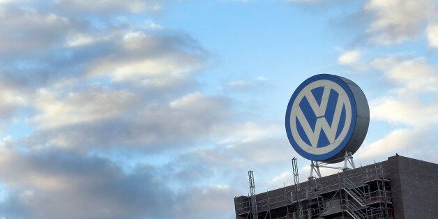 FILE - In this Sept. 26, 2015 file photo a giant logo of the German car manufacturer Volkswagen is pictured on top of a company's factory building in Wolfsburg, Germany. German prosecutors say they have widened their investigation of Volkswagen to include suspicion of tax evasion after revelations that some of its cars were emitting more carbon dioxide than officially reported. Braunschweig prosecutor Birgit Seel told The Associated Press on Tuesday Nov. 24, 2015 that the investigation was focused on five Volkswagen employees but would not release their names. (AP Photo/Michael Sohn, file)