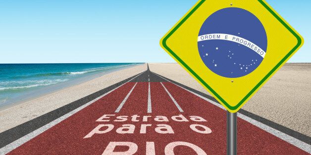 'Road to Brazil' in English with Brazilian flag sign leading along beach to Rio de Janeiro