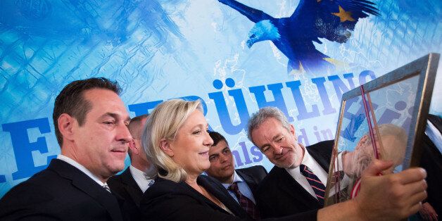 Chairman of the Austrian far right party FPOe Heinz Christian Strache (L) and President of French far-right party Front National Marine Le Pen (2nd L) admire a framed picture after a press conference prior to their meeting of the EU's far-right Europe for Nations and Freedom bloc, named 'Patriotic Spring - cooperation for friendship, safety and prosperity' on June 17, 2016, in Vienna, Austria / AFP / VLADIMIR SIMICEK (Photo credit should read VLADIMIR SIMICEK/AFP/Getty Images)