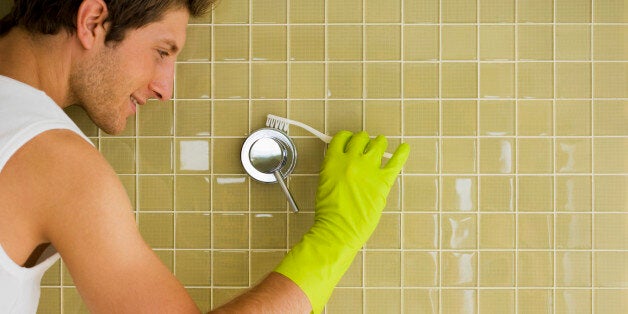 Man cleaning shower handle