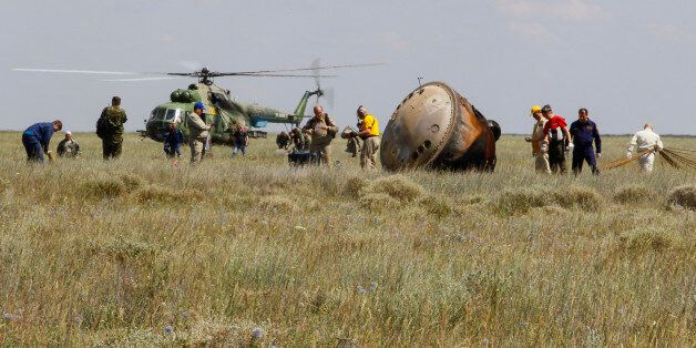 Members of a search and rescue team work at the site of landing of the Soyuz TMA-19M capsule carrying International Space Station (ISS) crew members, Tim Peake of Britain, Yuri Malenchenko of Russia and Tim Kopra of the U.S., near the town of Zhezkazgan, Kazakhstan, on June 18, 2016. / AFP / POOL / SHAMIL ZHUMATOV (Photo credit should read SHAMIL ZHUMATOV/AFP/Getty Images)