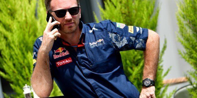 Infiniti Red Bull Racing's Team Chief Christian Horner speaks on his mobile phone in the paddock at the Baku City Circuit, on June 18, 2016 in Baku, before the third practice session for the European Formula One Grand Prix. / AFP / ANDREJ ISAKOVIC (Photo credit should read ANDREJ ISAKOVIC/AFP/Getty Images)