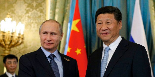 FILE - In this Friday, May 8, 2015 file photo Russian President Vladimir Putin, left, shakes hands with his Chinese counterpart Xi Jinping during their meeting in the Kremlin in Moscow, Russia. With President Vladimir Putin heading to China this weekend, officials in both countries extoll a blossoming âstrategic partnershipâ between the two former Communist rivals. (AP Photo/Alexander Zemlianichenko, pool, File)