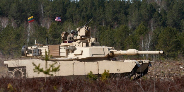 U.S. soldiers from the 2nd Battalion, 1st Brigade Combat Team, 3rd Infantry Division ride on an M1A2 Abrams battle tank during a military exercise at the Gaiziunu Training Range in Pabrade some 60km.(38 miles) north of the capital Vilnius, Lithuania, Thursday, April 9, 2015. The U.S has been maintaining a persistent presence of rotating land forces on the ground in the Baltic States and Poland since April 2014. (AP Photo/Mindaugas Kulbis)