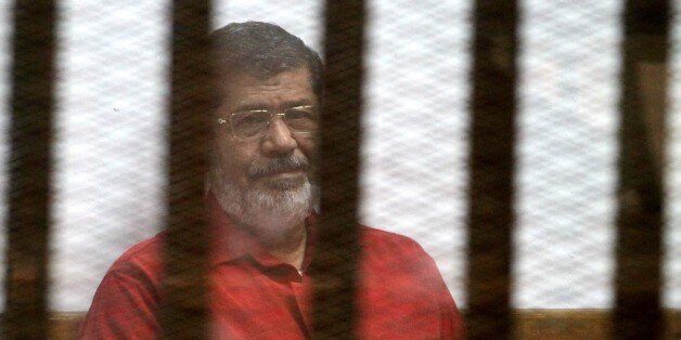 CAIRO, EGYPT - MARCH 7: Egypts ousted President Mohamed Morsi is seen behind the bars during his trial on charges of espionage on behalf of Qatar at the Police Academy in Cairo, Egypt on March 7, 2016. (Photo by Ahmed Gamil/Anadolu Agency/Getty Images)