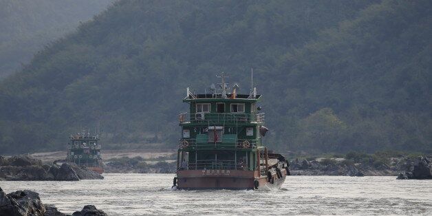 Chinese cargo ships sail on the Mekong river near the Golden Triangle at the border between Laos, Myanmar and Thailand March 1, 2016. Patrols on the Mekong River by the Laotian army and Myanmar police have subdued pirates who once robbed cargo ships with impunity. But drug production and trafficking in the region, known as the Golden Triangle, is booming - despite the presence of Chinese gunboats and Chinese armed police. The United Nations Office on Drugs and Crime estimates that Southeast Asia's trade in heroin and methamphetamine was worth $31 billion in 2013. REUTERS/Jorge Silva SEARCH