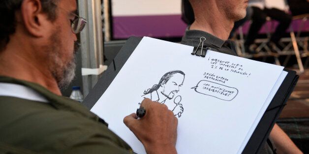 A man sketches a portrait of the leader of left wing party Podemos and party candidate for the upcoming general elections, Pablo Iglesias during a campaign meeting in Vitoria on June 21, 2016. Spain is holding its second elections in six months, on June 26, after being governed by a caretaker government with limited powers since the December 20 polls put an end to the country's traditional two-party system as voters fed up with austerity and corruption scandals flocked to new groups. / AFP / ANDER GILLENEA (Photo credit should read ANDER GILLENEA/AFP/Getty Images)