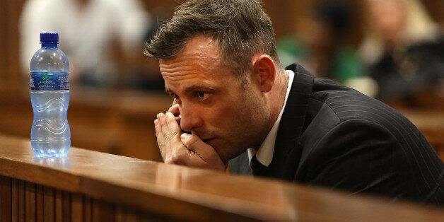 South African Paralympian Oscar Pistorius speaks on the phone on the third day of his hearing at the Pretoria High Court for sentencing procedures in his murder trial in Pretoria on June 15, 2016.The final witness was due to appear at Oscar Pistorius's sentencing hearing on June 15 as the paralympic athlete awaits a new jail term for murdering his girlfriend Reeva Steenkamp three years ago. / AFP / POOL AND AFP / Alon Skuy (Photo credit should read ALON SKUY/AFP/Getty Images)
