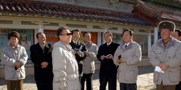 In this photo released on Friday, Dec. 12, 2008, by the official (north) Korean Central News Agency via Korea News Service in Tokyo without mentioning the exact date when it was taken, North Korean leader Kim Jong Il, third left, visits the Folk Village with restaurants, an amusement park and a history exhibition area in Sariwon city, west of Pyongyang. (AP Photo/Korean Central News Agency via Korea News Service) ** SOUTH KOREA OUT **
