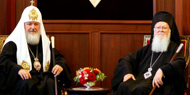 Ecumenical Greek Orthodox Patriarch Bartholomew I (R) and Russian Orthodox Patriarch Kirill pose for media at the Fener Greek Orthodox patriarchate in Istanbul July 4, 2009.The spiritual leader of the world's Orthodox Christians and the head of the Russian Orthodox Church put on a united front on Saturday as they met for talks in Istanbul. REUTERS/Kerim Okten/Pool (TURKEY SOCIETY RELIGION)