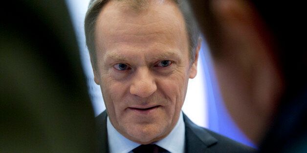 European Council President Donald Tusk speaks with journalists as he arrives at the European Council building in Brussels on Wednesday, Feb. 17, 2016. European Union leaders will hold a summit in Brussels on Thursday and Friday to hammer out a deal designed to keep Britain in the 28-nation bloc. (AP Photo/Virginia Mayo)