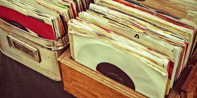 Retro styled image of boxes with vinyl turntable records on a flee market