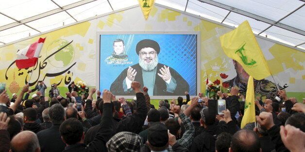 Lebanon's Hezbollah leader Sayyed Hassan Nasrallah addresses his supporters via a screen during a commemoration service marking one week since the death of Ali Fayyad, one of Hezbollah's senior commanders killed fighting alongside Syrian army forces in Syria, in Ansar village, southern Lebanon March 6, 2016. REUTERS/Aziz Taher