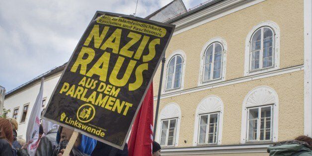 TO GO WITH STORY BY NINA LAMPARSKIProtesters gather outside the house where Adolf Hitler was born during the anti-Nazi protest in Braunau Am Inn, Austria on April 18, 2015. The weatherworn, three-storey structure in the central square of Braunau has stood empty since 2011 and cannot be knocked down because it is a listed building, although not because of Hitler. AFP PHOTO/JOE KLAMAR (Photo credit should read JOE KLAMAR/AFP/Getty Images)