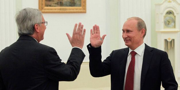 Russian President Vladimir Putin, right, and Luxembourg Prime Minister Jean-Claude Juncker greet each other during their meeting in the Moscow's Kremlin, Russia, on Tuesday, Sept. 25, 2012. (AP Photo/Yuri Kochetkov, pool)