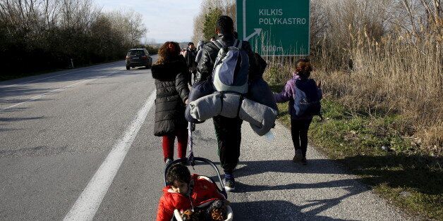 A stranded refugee pulls a crib with one of his children as his family walks along a national motorway towards the Greek-Macedonian border near the Greek town of Polykastro after ignoring warnings from Greek authorities that the border is shut, as hundreds of migrants set off on the country's main north-south motorway to Idomeni border crossing February 25, 2016. REUTERS/Yannis Behrakis TPX IMAGES OF THE DAY
